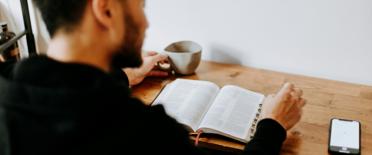 Estudiando la Palabra de Dios Un hombre sentado estudiando la Biblia